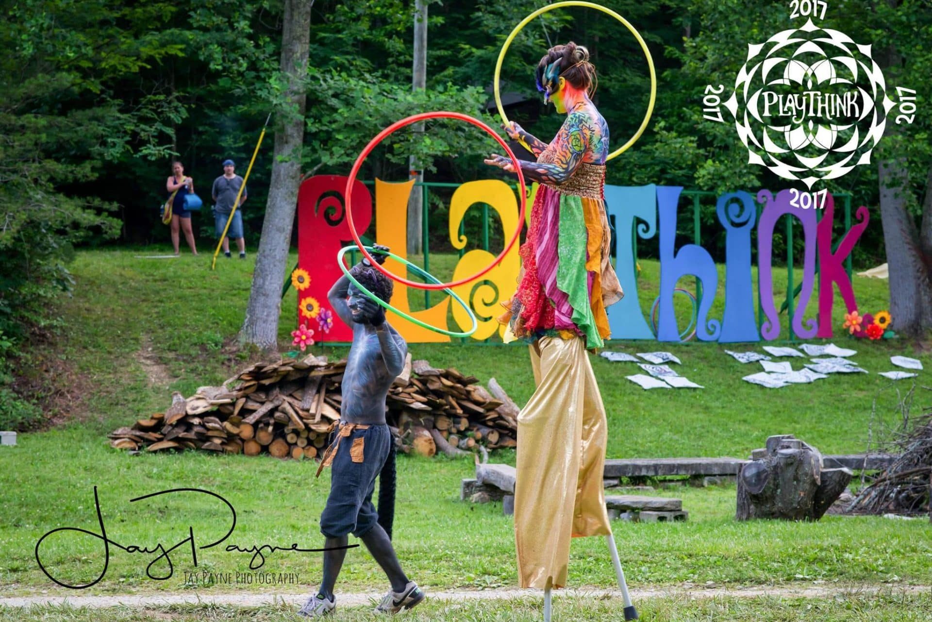 About PlayThink - Performers stilt walking and hooping at PlayThink 2017
